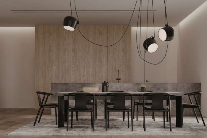 Des luminaires industriels noirs suspendus au-dessus d'une table à manger moderne en marbre, parfaits comme luminaire pour une salle à manger.